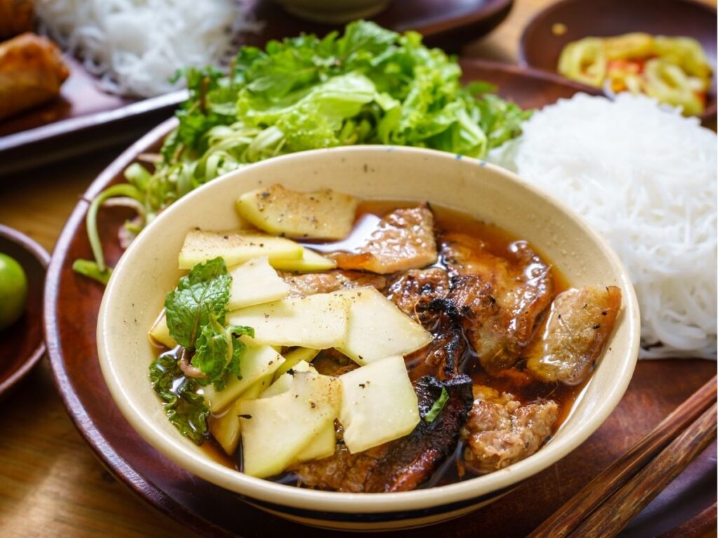 Plato de bun cha con fideos de arroz, carne a la parrilla y hierbas frescas